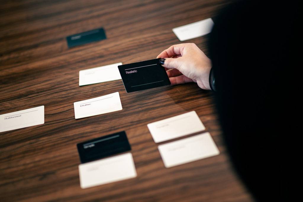 A table with a selection of brand voice cards as part of a workshop with Honest Communications