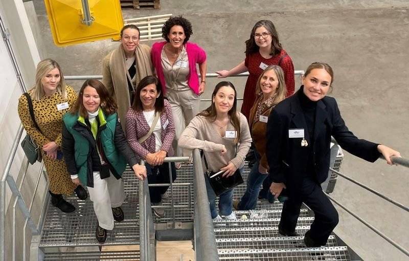 A group of women standing on a metal staircase