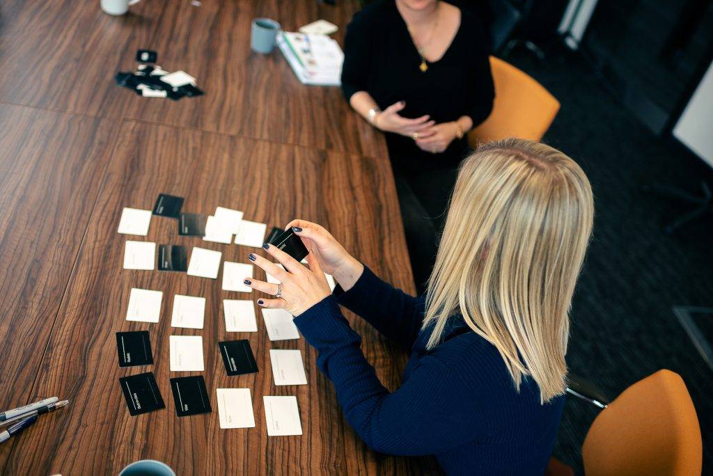 Two females working through a brand voice exercise at a desk